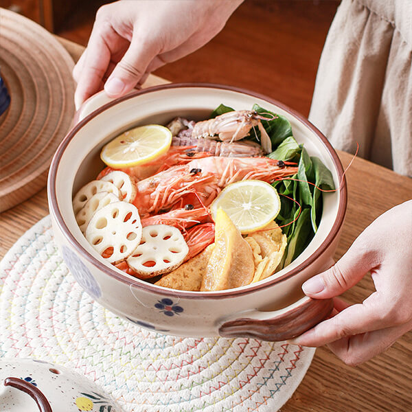 Artisan hand-painted ceramic casserole showing detailed floral motifs Japanese clay pot craftsmanship