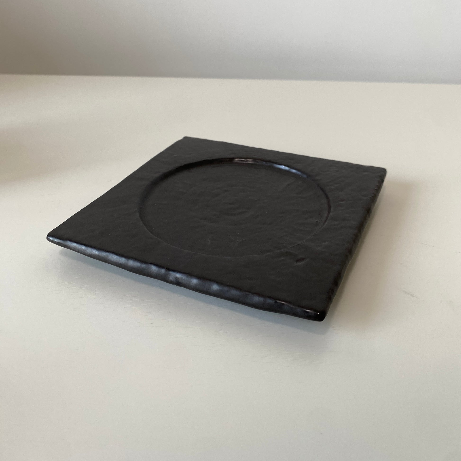 Black square plate on a white surface