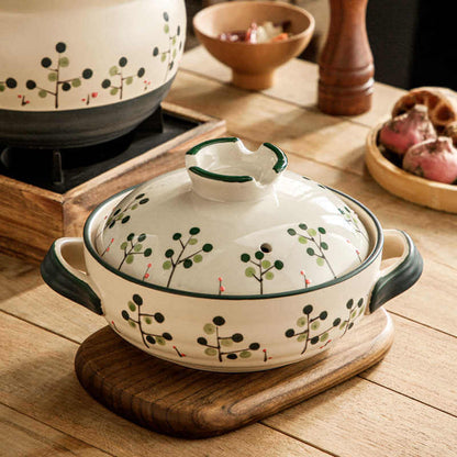 Hand-painted botanical berry pattern ceramic casserole Japanese donabe with green blue berries detail view